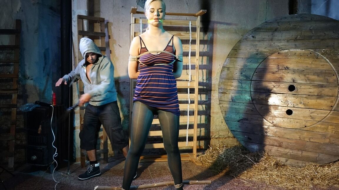 10P Tall female Nikki Dream is gagged and restrained for a fully clothed flogging