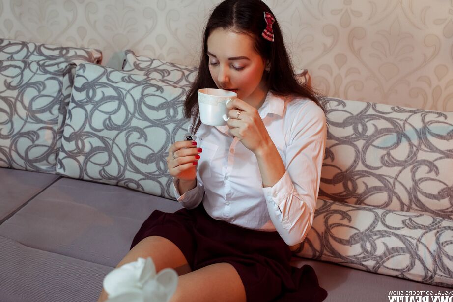 20P Young brunette Sofa gets completely naked after taking tea on a sofa