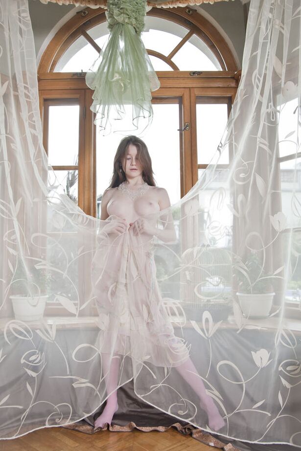 12P Slender teen Emily Bloom models naked by herself in over the knee socks