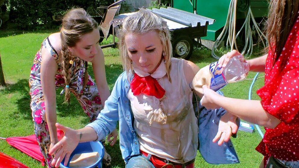 14P Young girls soak each other in a backyard while washing a compact vehicle