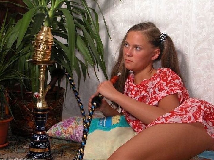 14P Young girl puts down a hookah pipe before showing her tiny tits and vagina