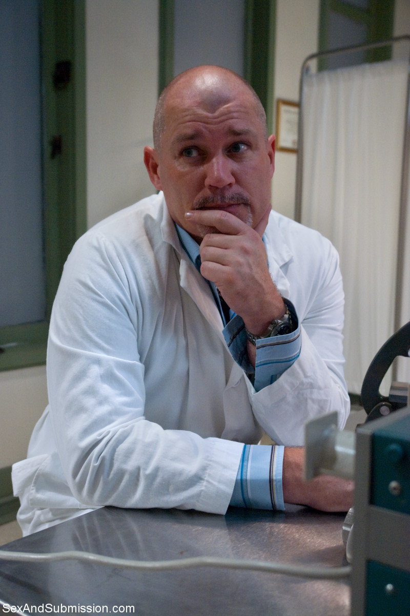 17P Bald doctor examines naked body of good-looking assistant in people's presence