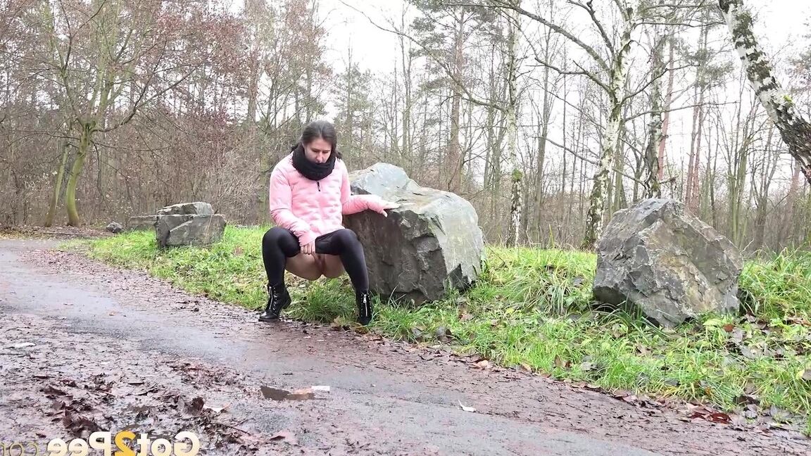 15P Lara Fox squats and pees at the edge of a road