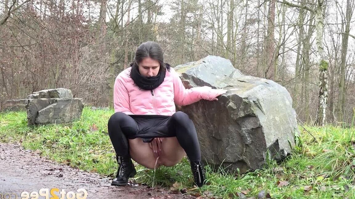 15P Lara Fox squats and pees at the edge of a road