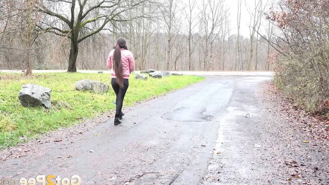 15P Lara Fox squats and pees at the edge of a road