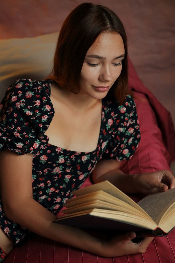 18P Janey reads a book on the bed and decides to strip off her floral top and