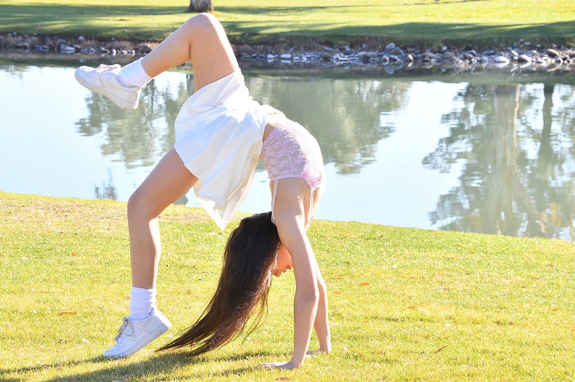 15P Brunette amateur Dakota does a cartwheel in a park before getting naked