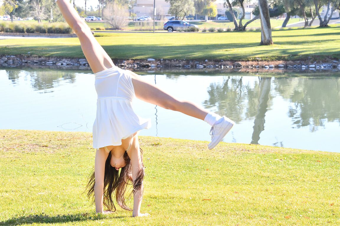 15P Brunette amateur Dakota does a cartwheel in a park before getting naked