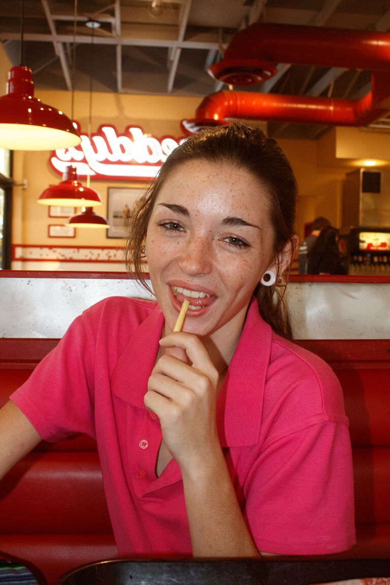 12P Skinny babe Hannah Tarley shows her panties an upskirt at a fast food joint