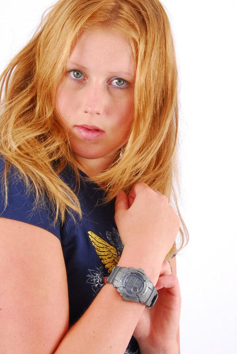 16P Natural redhead Judy displays her grey G-Shock watch in a T-shirt and jeans