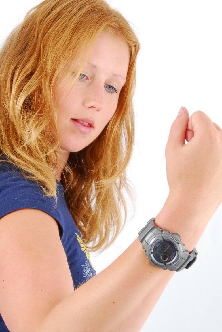 16P Natural redhead Judy displays her grey G-Shock watch in a T-shirt and jeans