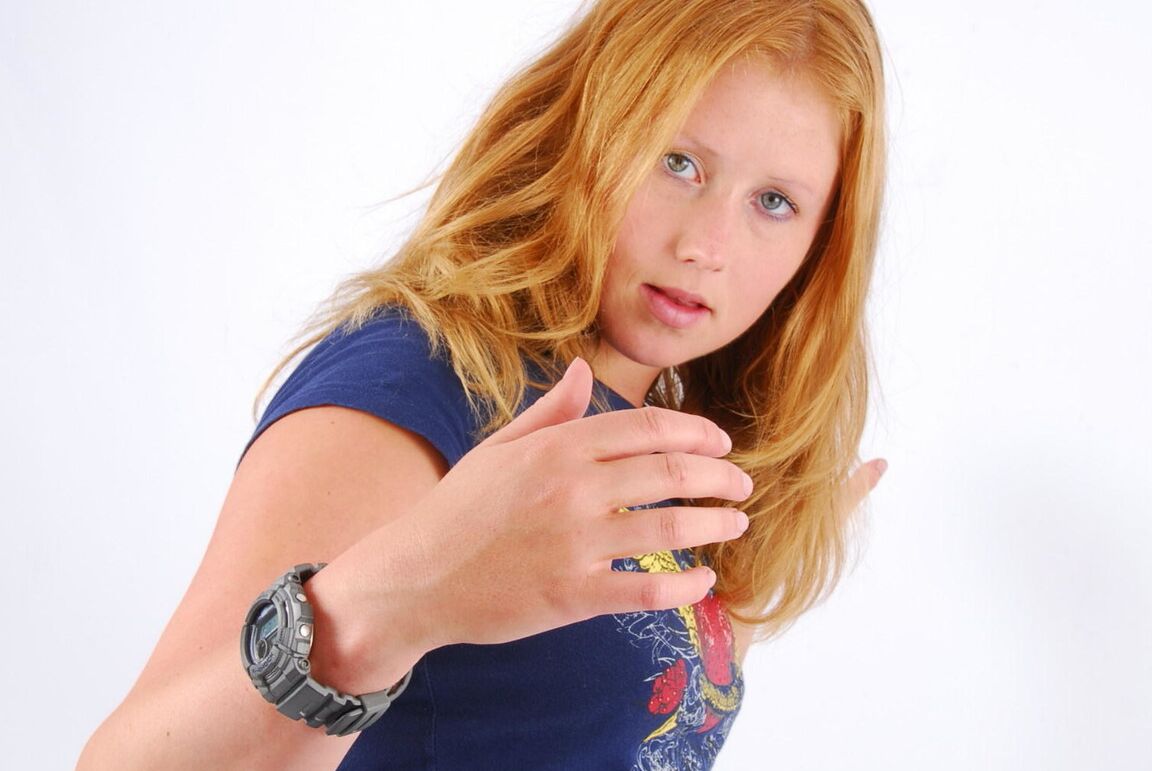 16P Natural redhead Judy displays her grey G-Shock watch in a T-shirt and jeans