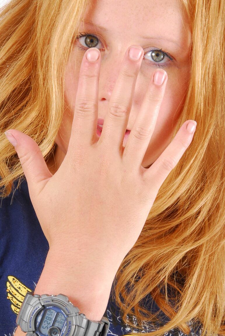 16P Natural redhead Judy displays her grey G-Shock watch in a T-shirt and jeans