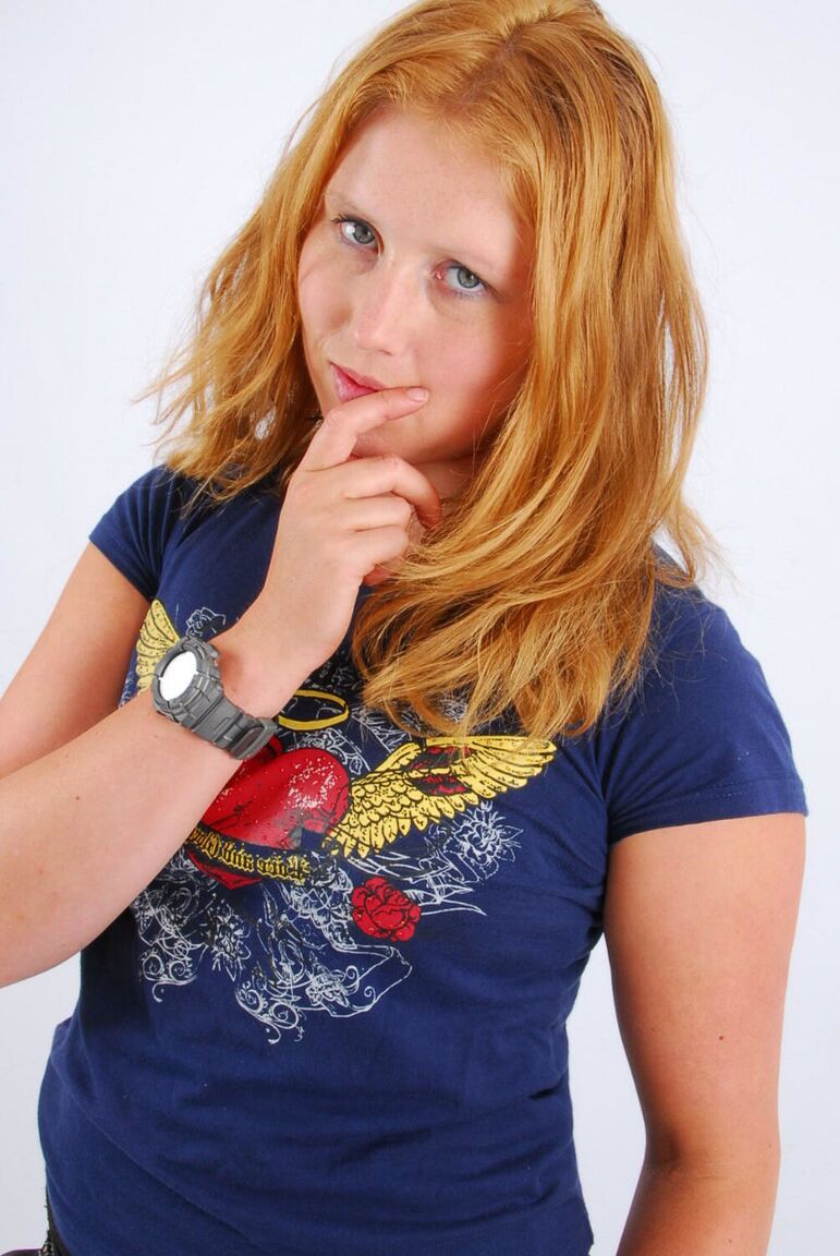 16P Natural redhead Judy displays her grey G-Shock watch in a T-shirt and jeans