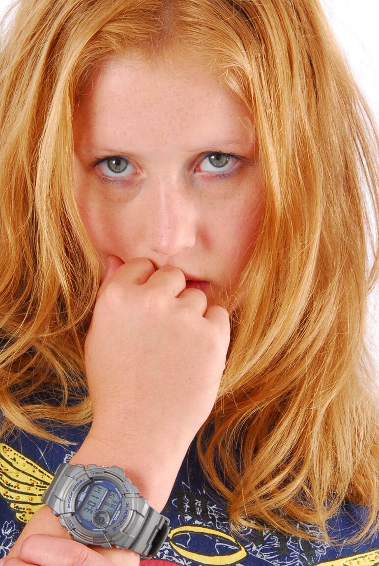 16P Natural redhead Judy displays her grey G-Shock watch in a T-shirt and jeans