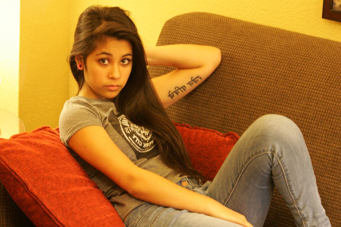21P Linda modelo adolescente árabe posando de camisa e jeans justos em um casting