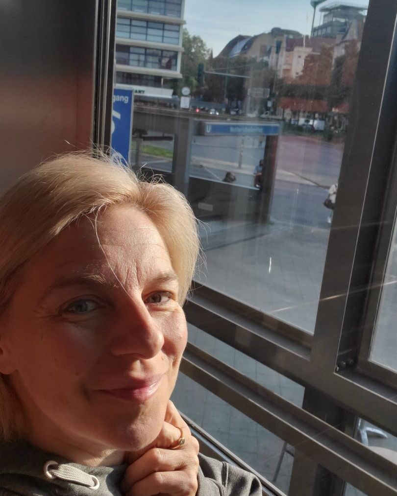 11P Blauäugige reife Blondine stellt ihren heißen, kurvigen Körper zur Schau, während sie im Fenster posiert