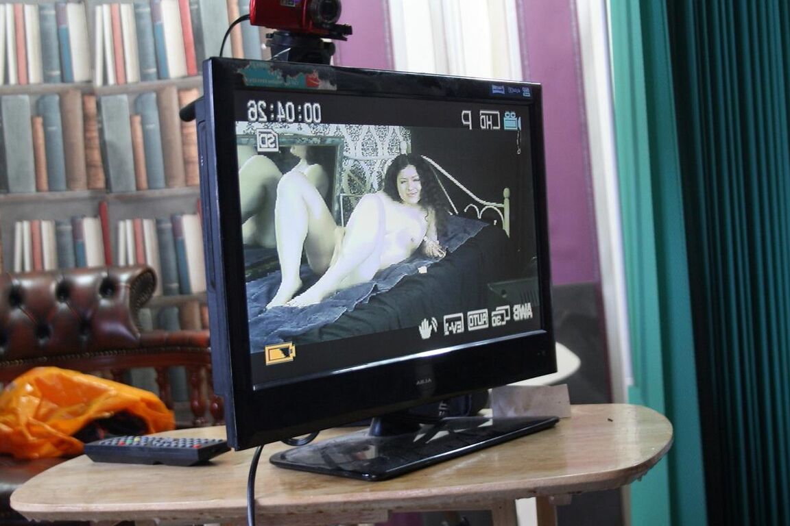 20P Curly-haired beauty poses nude & in a short dress in a behind the scenes solo