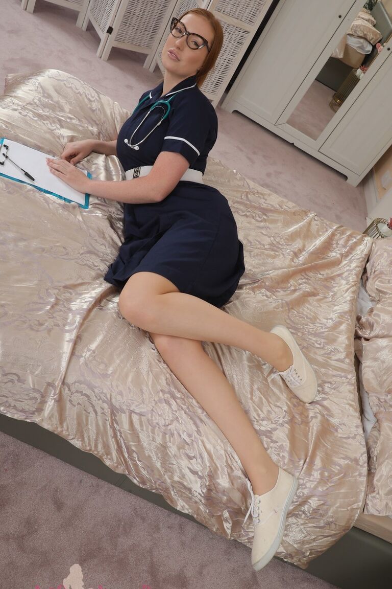 16P Natural redhead Alice Brookes releases her natural tits from her work uniform
