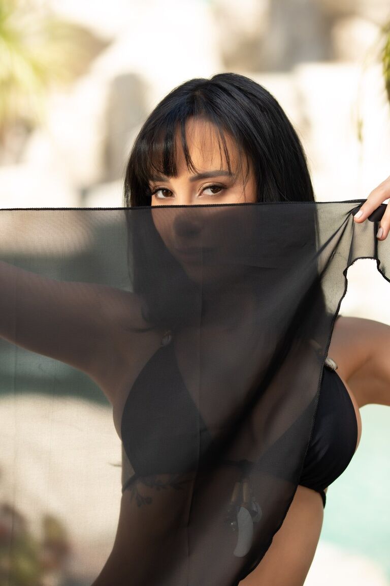 12P Centerfold model Veronica Perasso releases her hot body from a black bikini