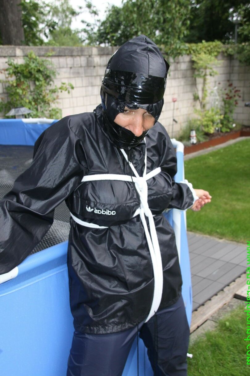 16 Photos La femme amateur Sandra est bâillonnée et attachée à une piscine dans un imperméable