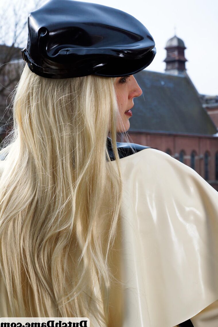 16 Pics Hot blonde flashes latex garters while modeling outdoors in rubber attire