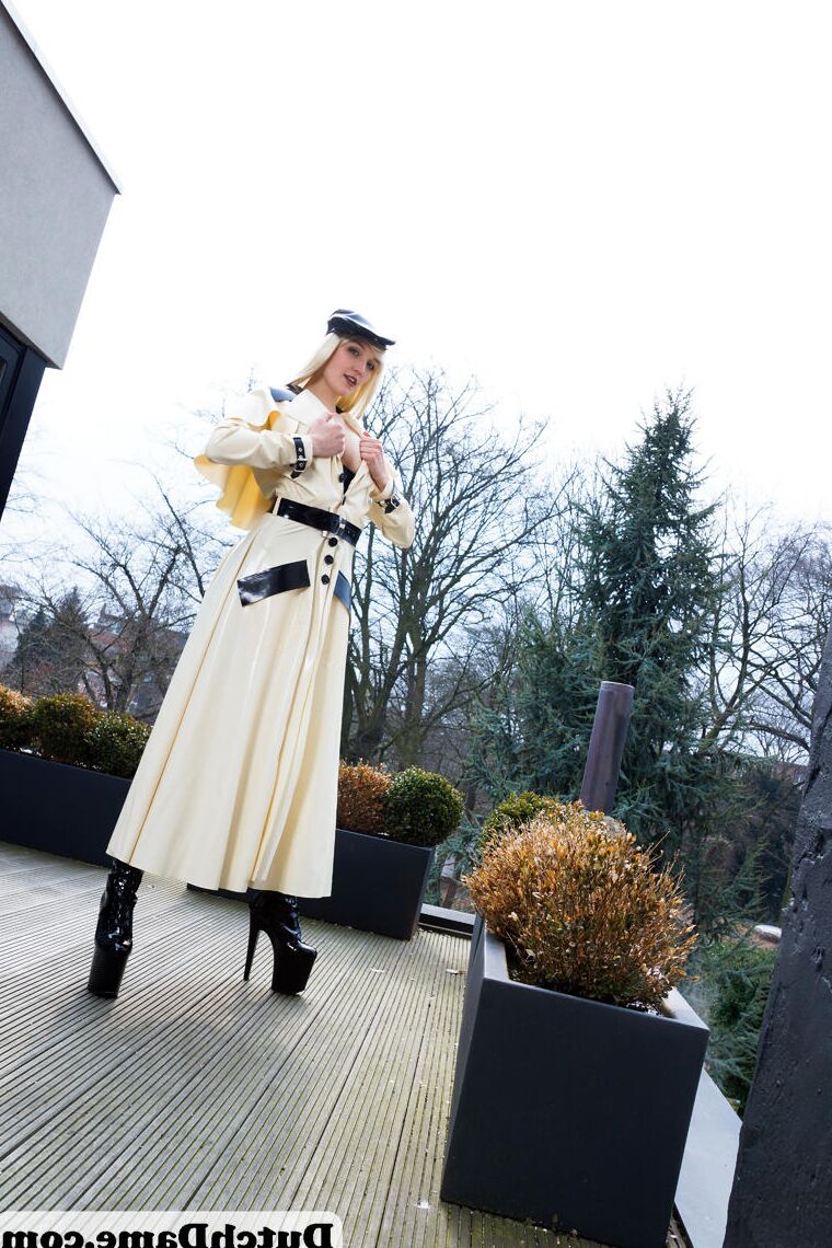16 Pics Hot blonde flashes latex garters while modeling outdoors in rubber attire