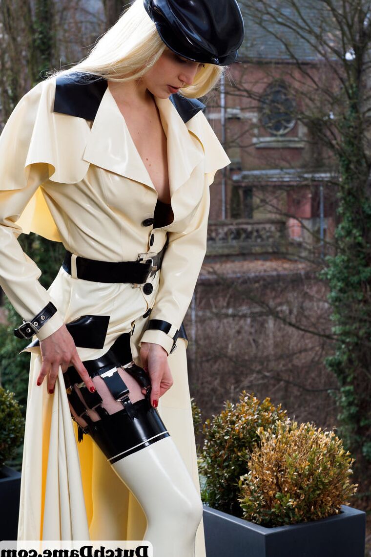 16 Pics Hot blonde flashes latex garters while modeling outdoors in rubber attire