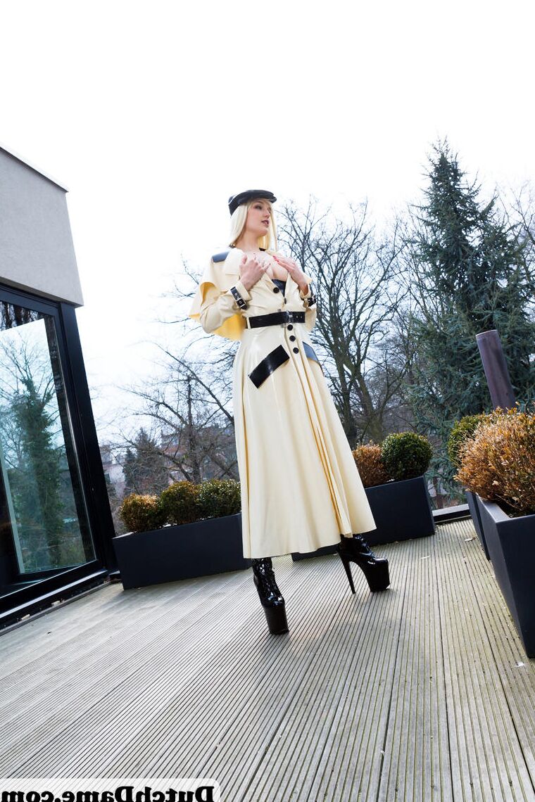 16 Pics Hot blonde flashes latex garters while modeling outdoors in rubber attire