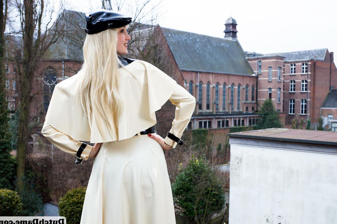 16 Pics Hot blonde flashes latex garters while modeling outdoors in rubber attire