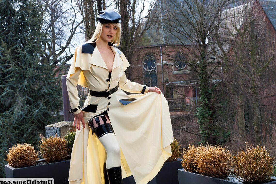 16 Pics Hot blonde flashes latex garters while modeling outdoors in rubber attire
