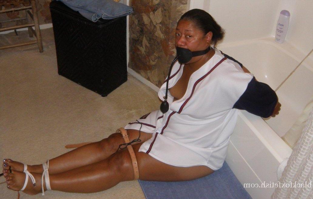 16P Ebony plumper is silenced with a pump up gag while restrained in a bathroom