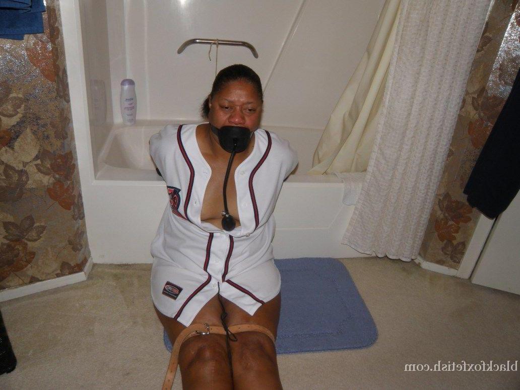 16P Ebony plumper is silenced with a pump up gag while restrained in a bathroom