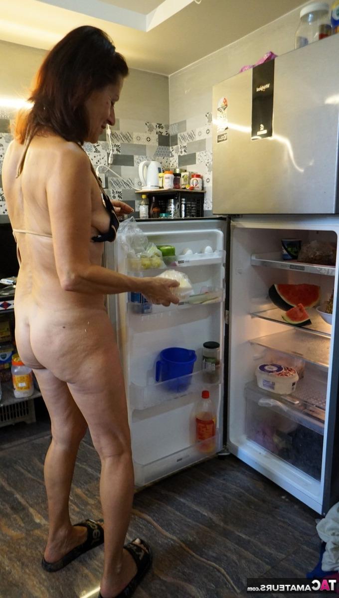 16P Diana Ananta, une femme mûre, prépare un repas tout en portant un bikini.
