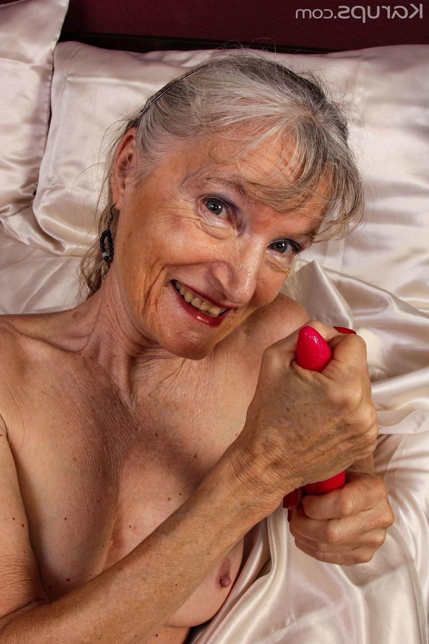20P Lisa Cognee, mamie maigre, expose ses seins naturels et se masturbe sur son lit.