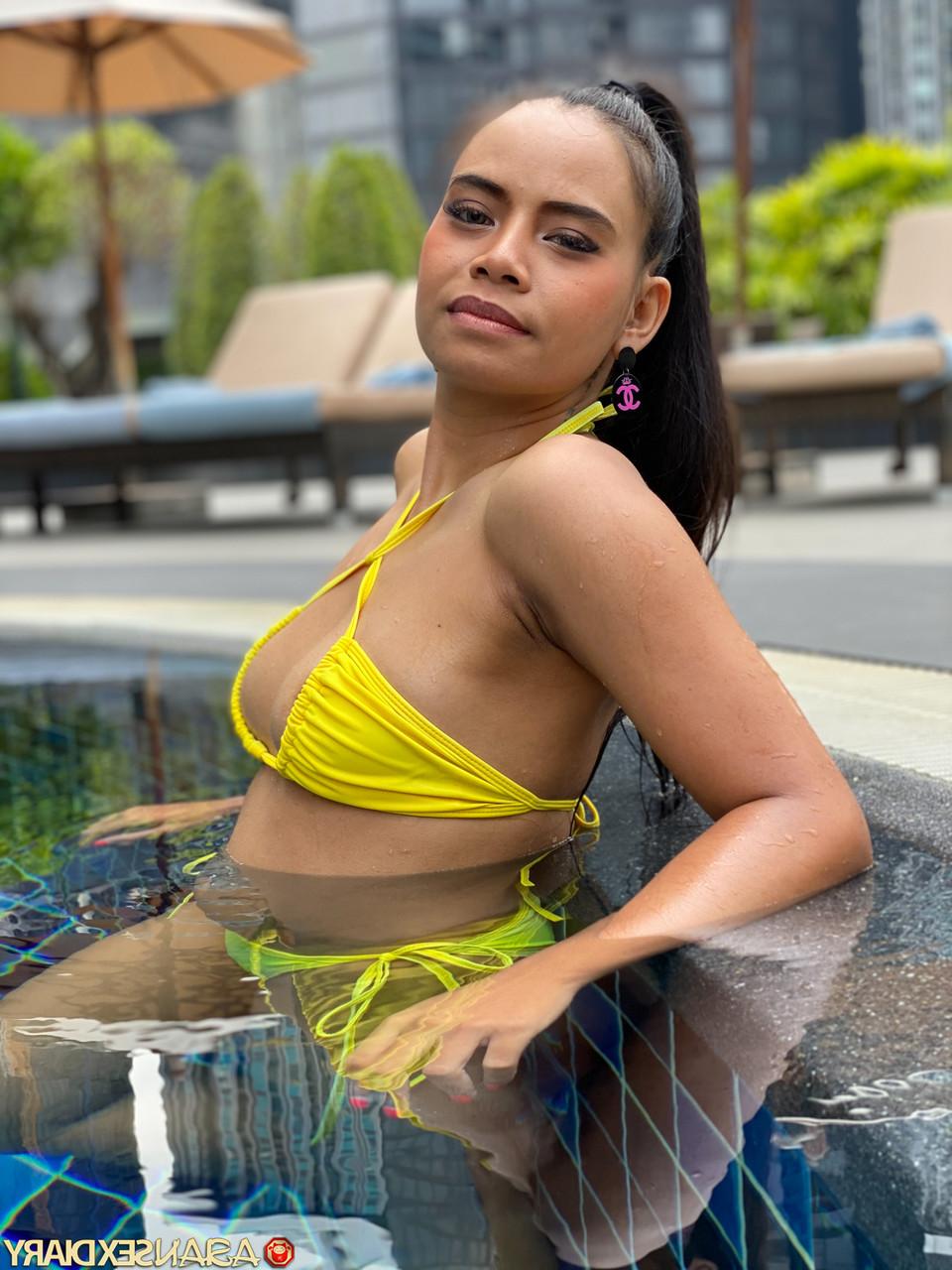 20P Cute Latina Barbie C flaunts her curves wearing a yellow bikini poolside