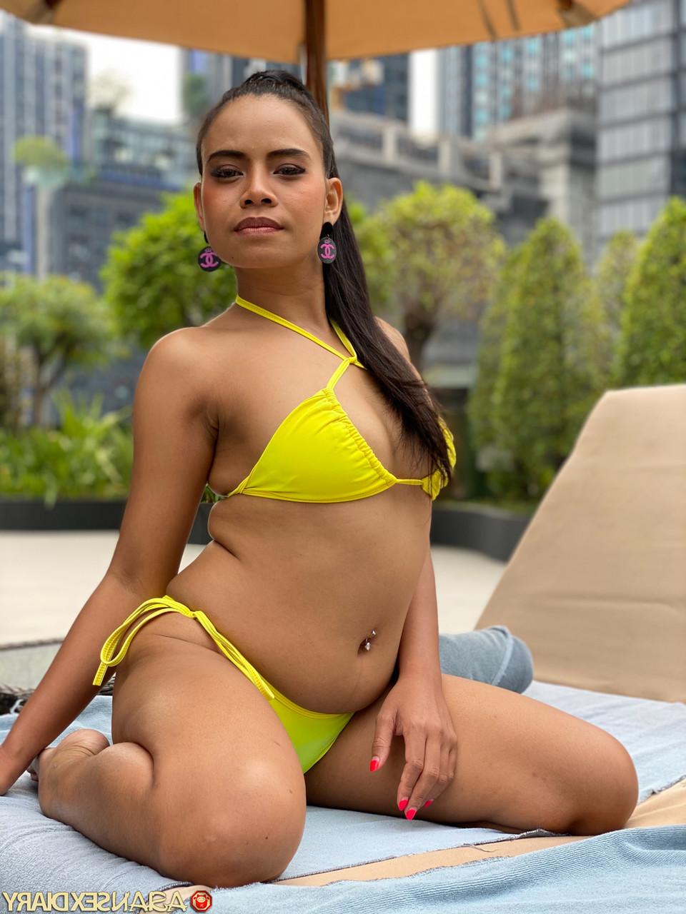 20P Cute Latina Barbie C flaunts her curves wearing a yellow bikini poolside