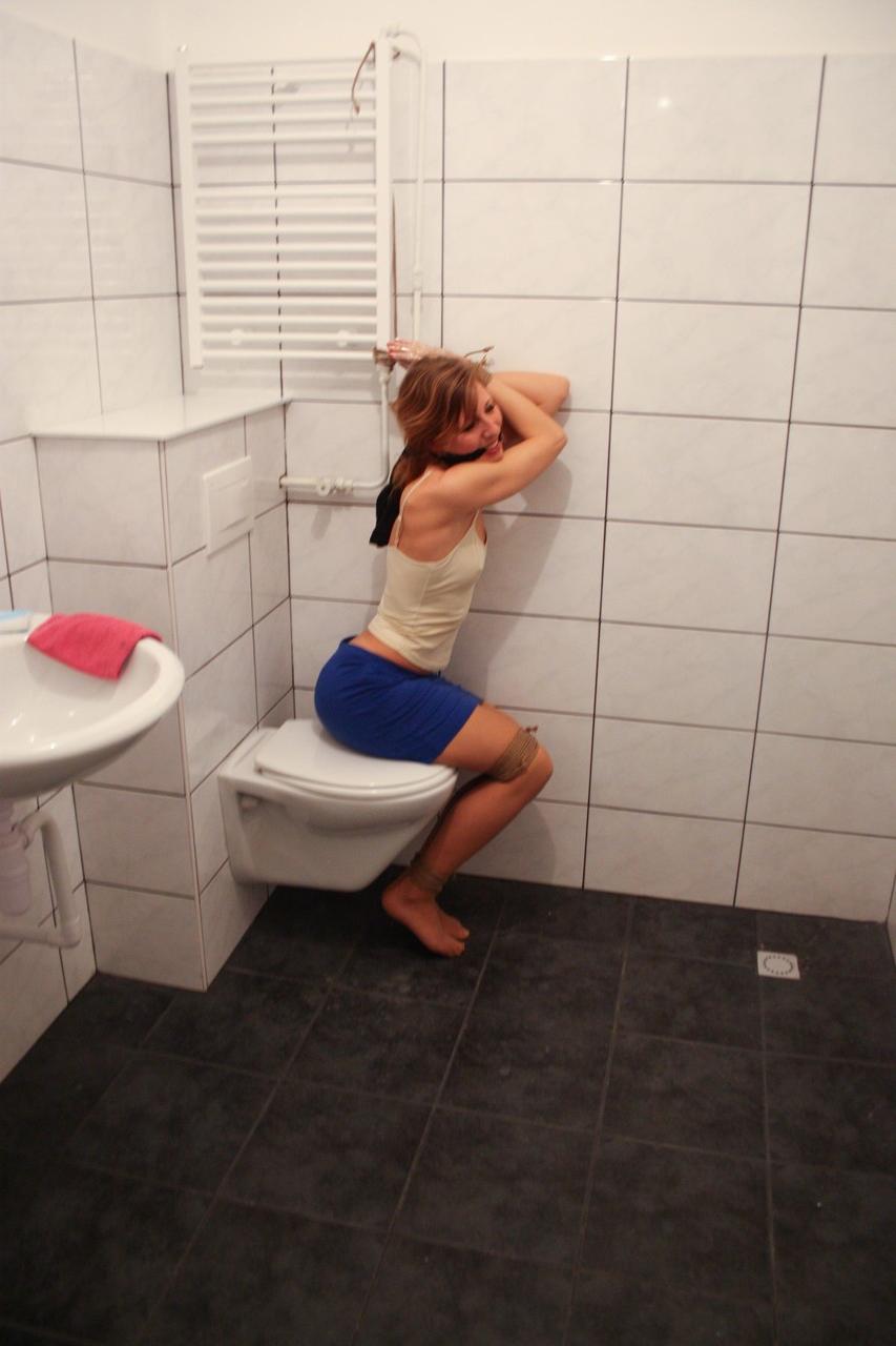 20P Brunette babe Eve struggles to free herself from bondage in the bathroom