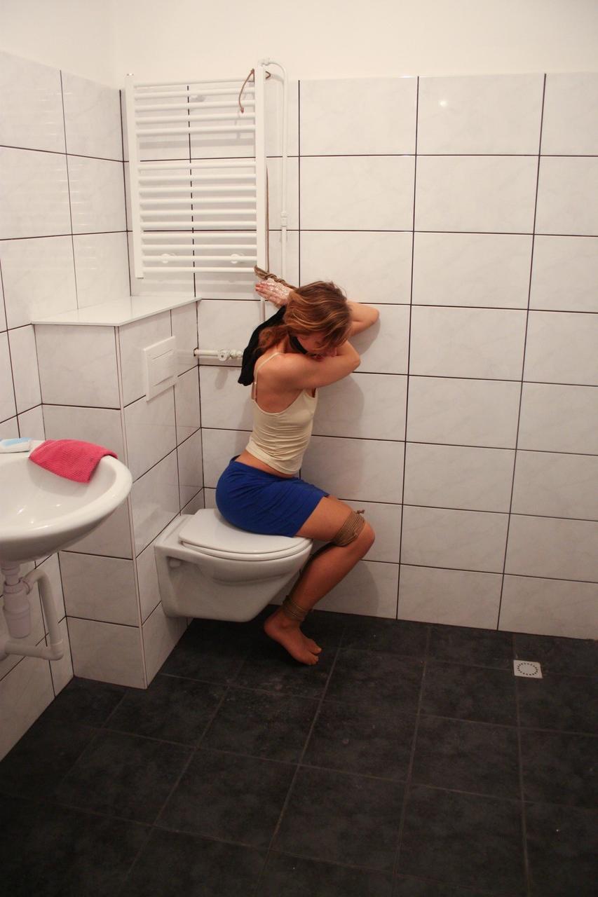 20P Brunette babe Eve struggles to free herself from bondage in the bathroom