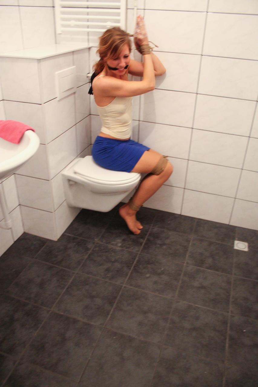 20P Brunette babe Eve struggles to free herself from bondage in the bathroom