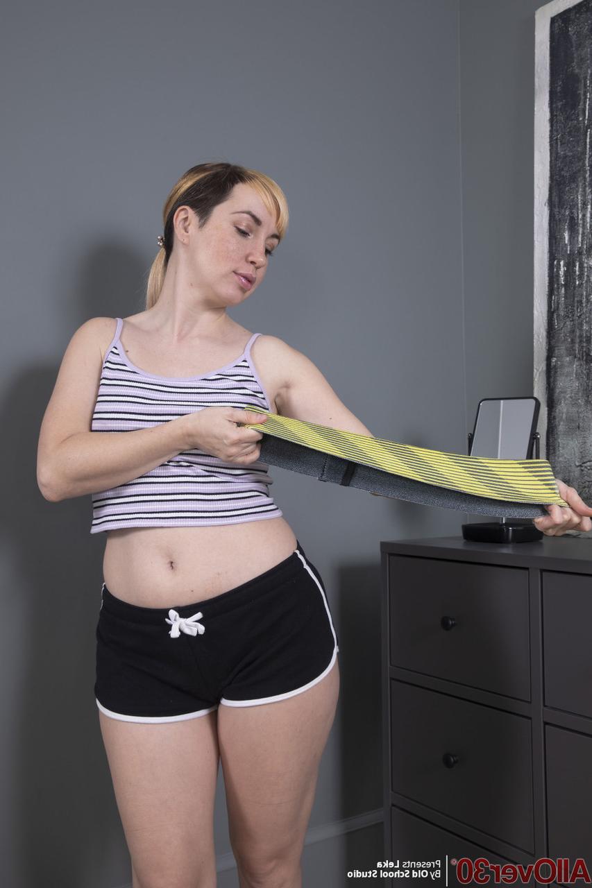 15P 30 plus lady Leka removes booty shorts while getting bare naked in her bedroom