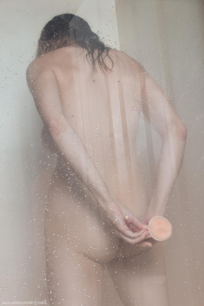 17P Busty cougar Dani riding her fuzzy snatch on dildo in the shower