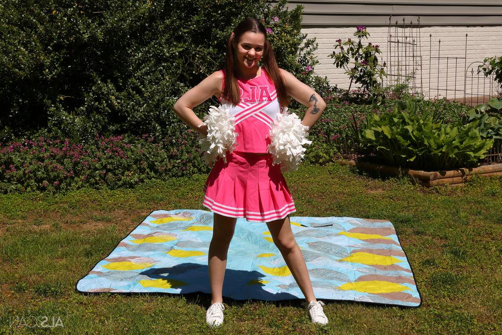 16P Cute cheerleader Trinity Olsen masturbates with a black dildo in a backyard