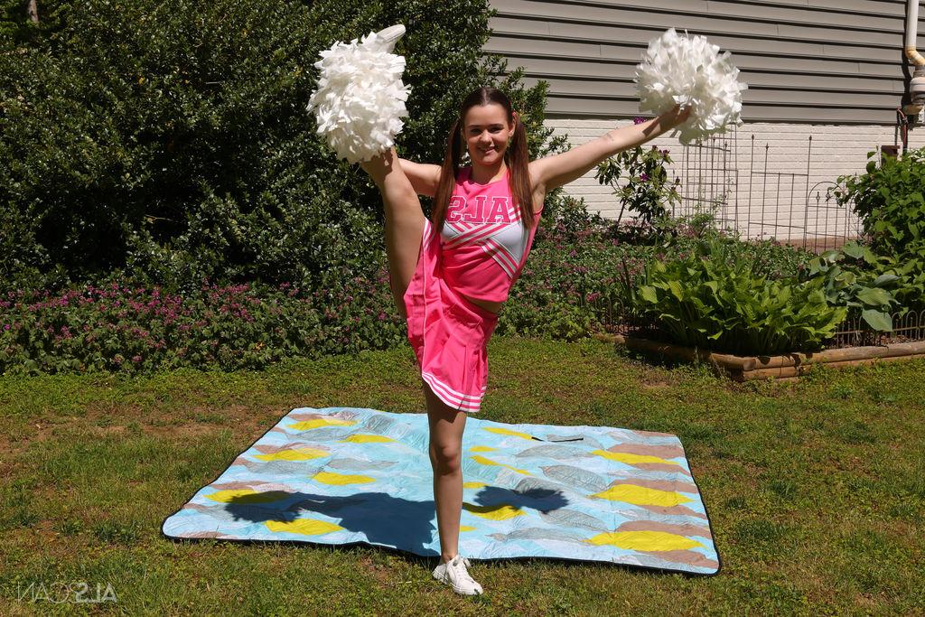 16P Cute cheerleader Trinity Olsen masturbates with a black dildo in a backyard