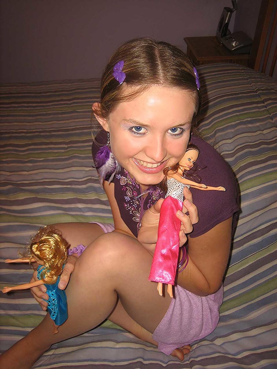 20P Cute brunette Kitty strips and toys herself after playing with Barbies