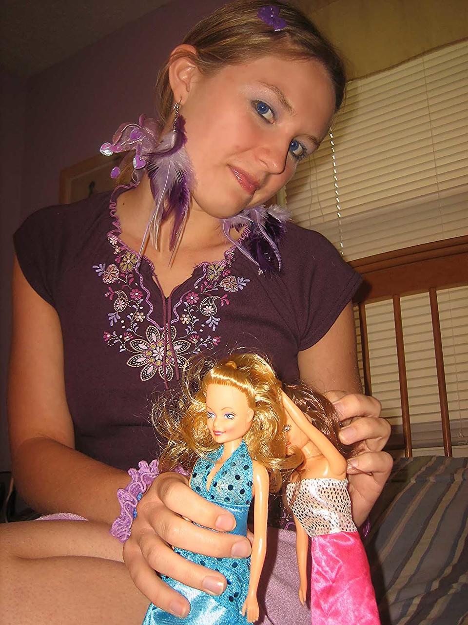 20P Cute brunette Kitty strips and toys herself after playing with Barbies