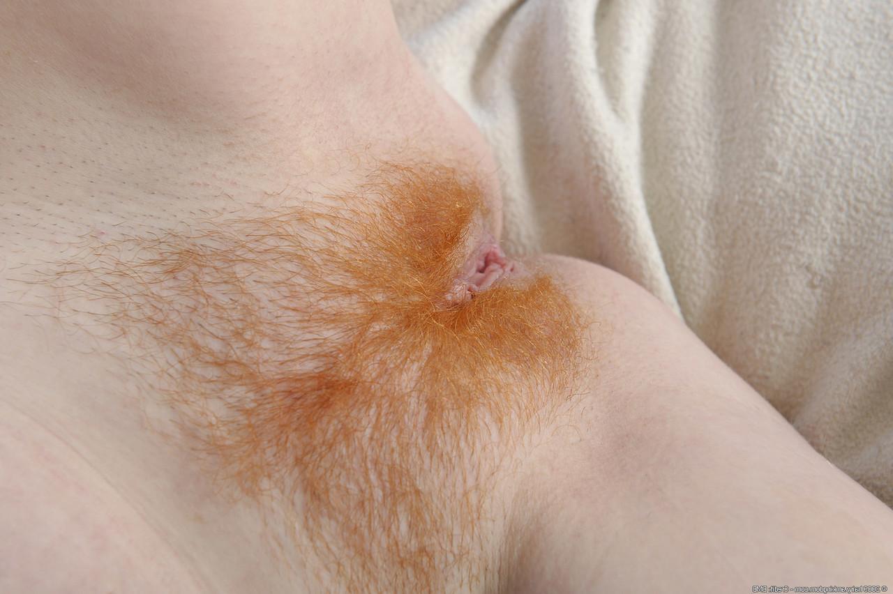 20P Redheaded lady Sasha strips and shows her big ass and spreads her hairy pussy