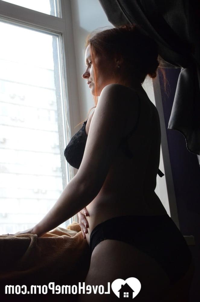 20P Redheaded amateur model strips by the window and touches her big juicy boobs
