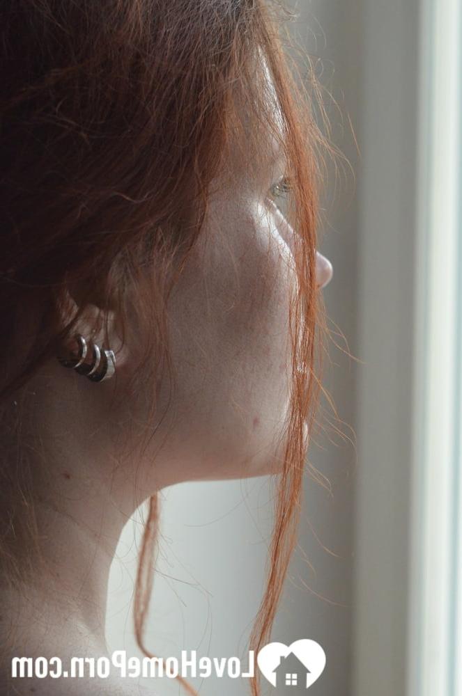 20P Redheaded amateur model strips by the window and touches her big juicy boobs