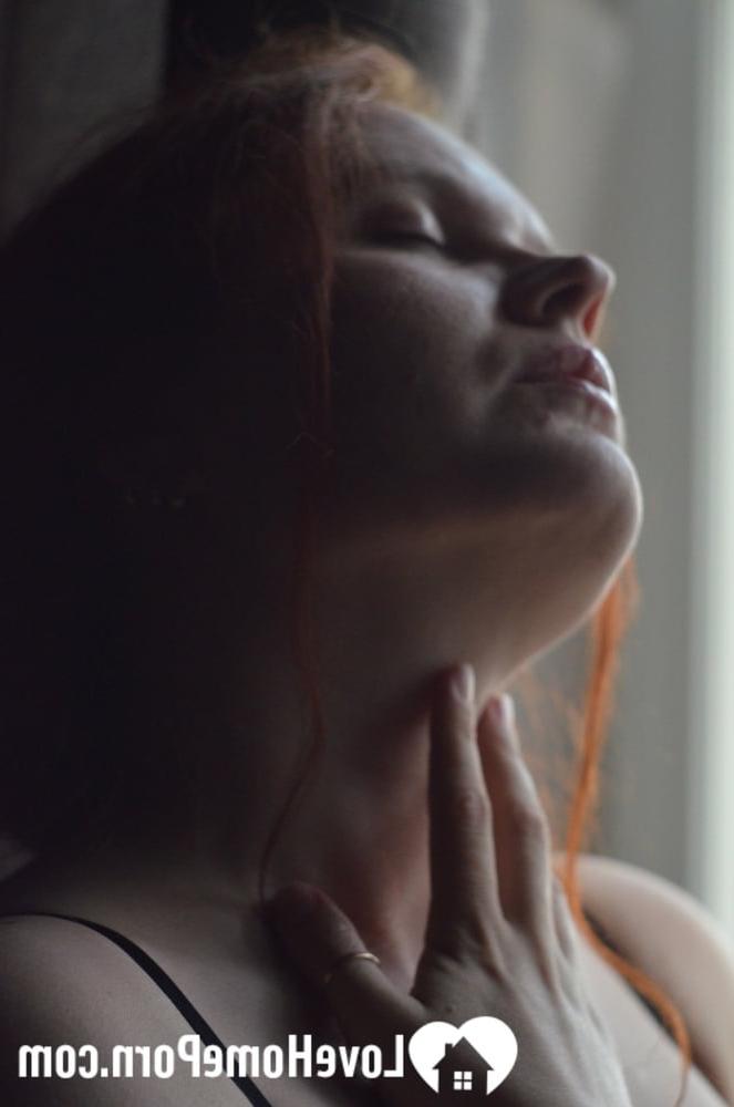 20P Redheaded amateur model strips by the window and touches her big juicy boobs